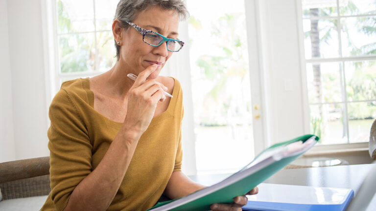 Woman researching state-mandated retirement plans.
