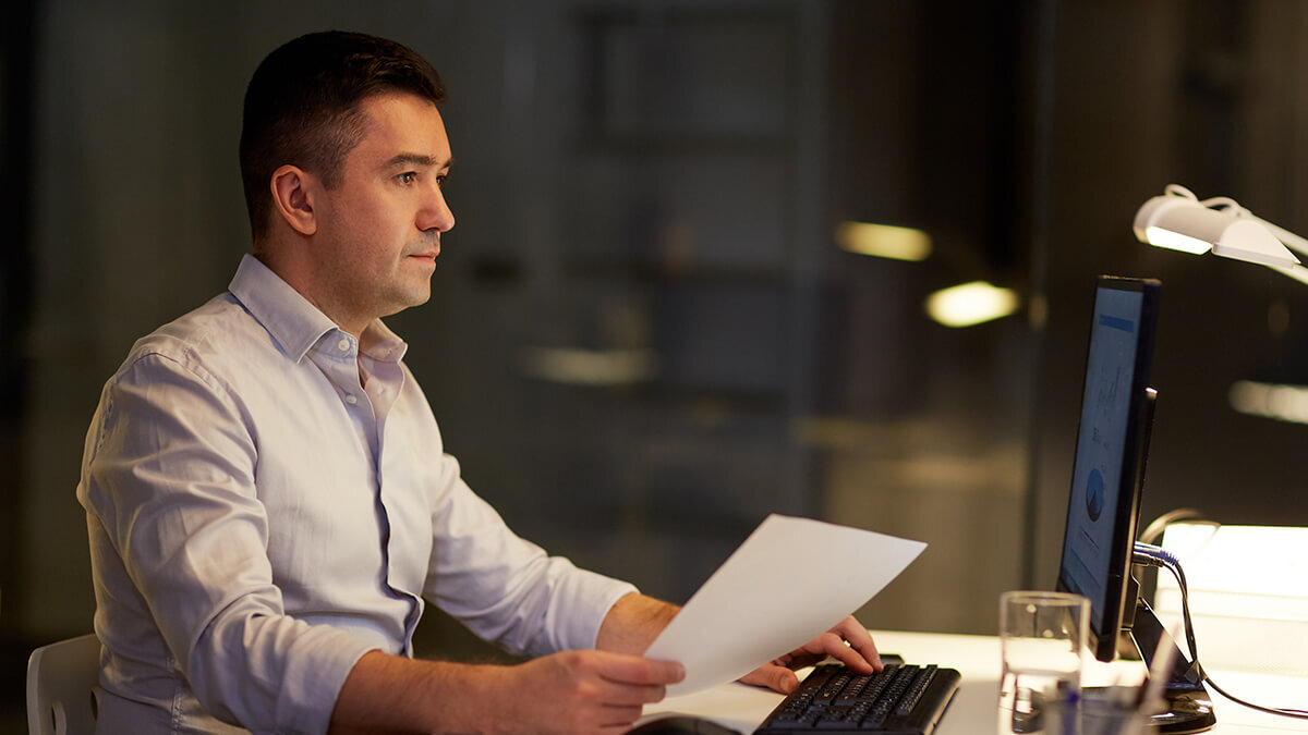 Man using a laptop late at night.