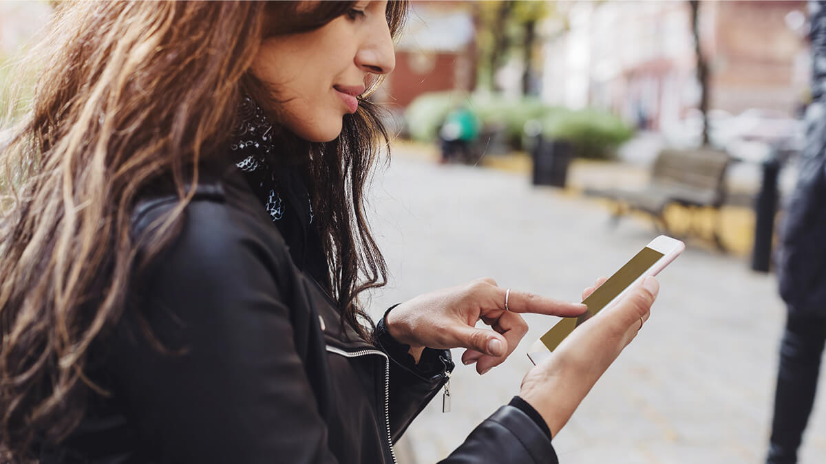 Woman outside using her phone.