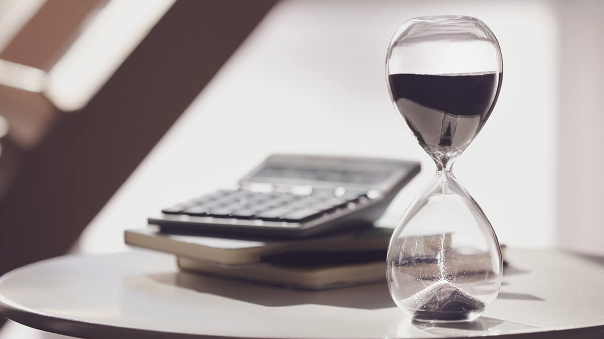 Hour glass and calculator on an end table