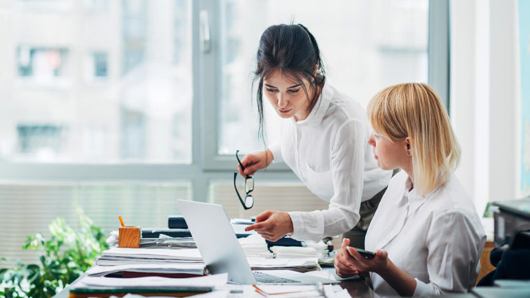 Two women talking in the office.
