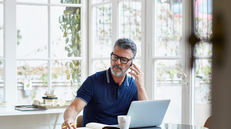 Man on the phone working from home.