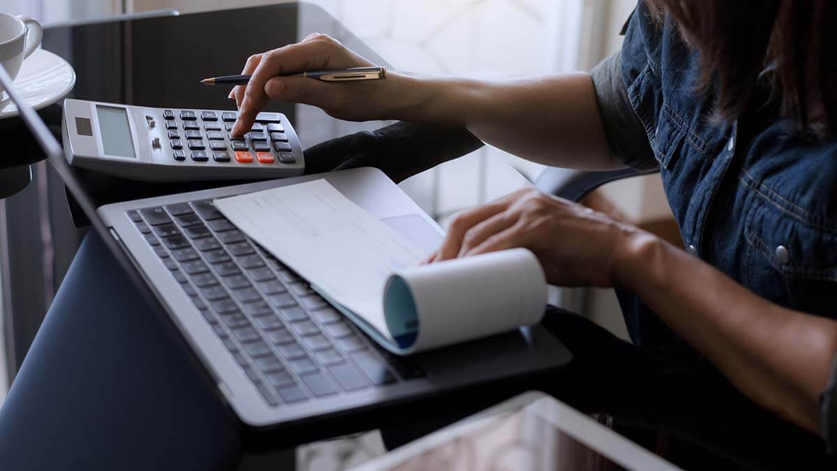 Employer calculating post-tax deductions before writing paycheck.