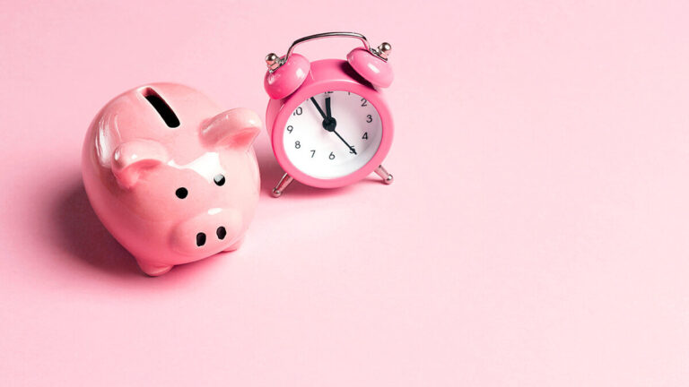 Pink piggy bank and alarm clock.