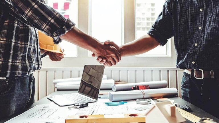 Contractor and business owner shaking hands.