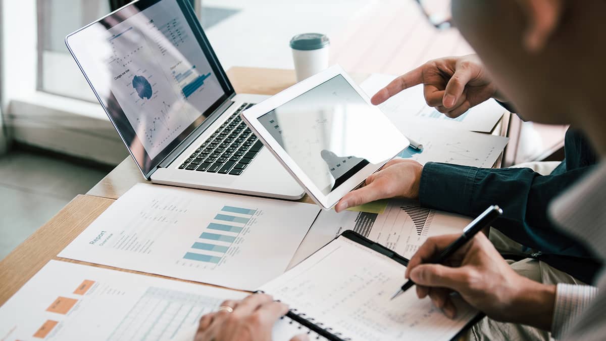 Financial statements spread across a table.