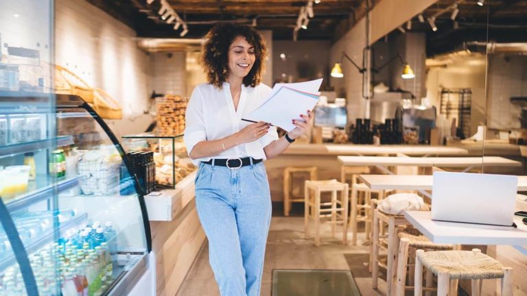 Restaurant owner looking at documents.
