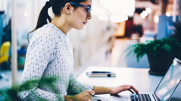 Employer reviewing tax exemption on a laptop.