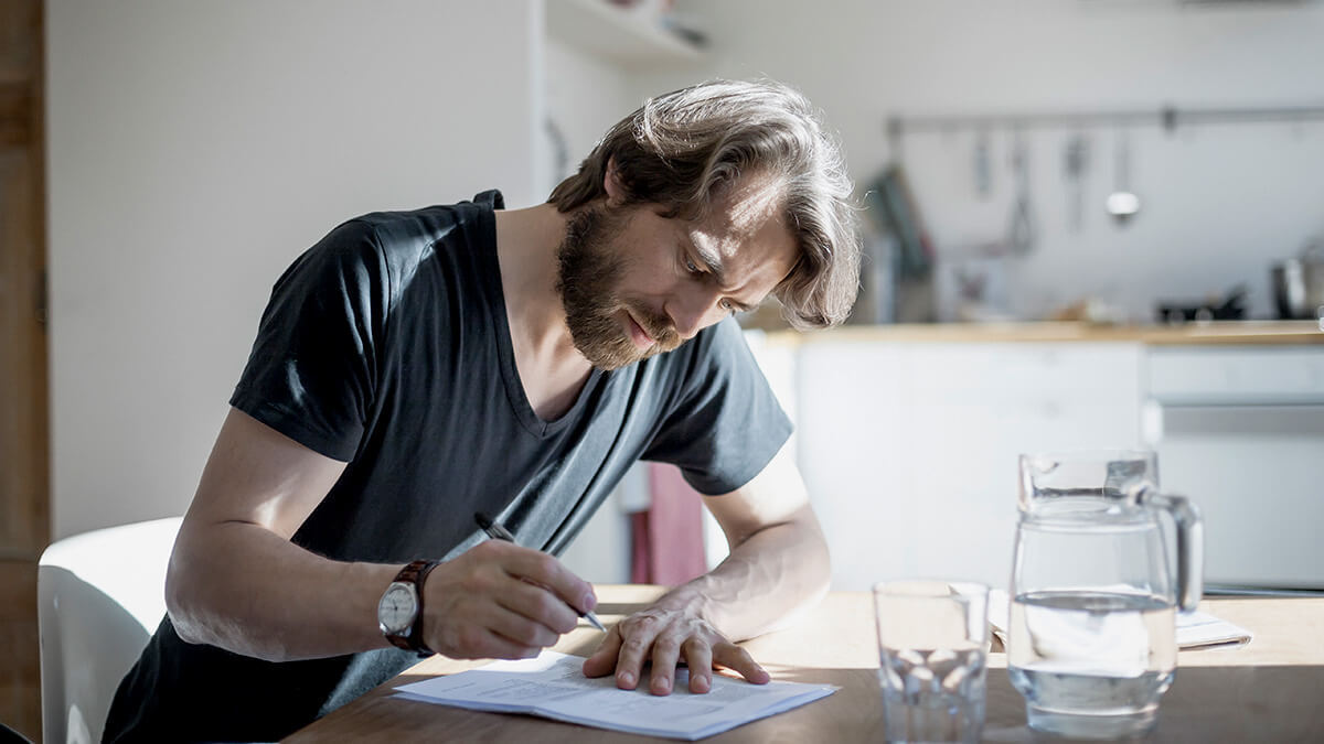 Man filling out Form W-2.