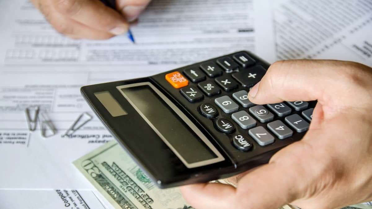 Hand using a calculator.