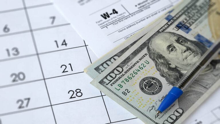 $100 bills, Form W-4, and a calendar.