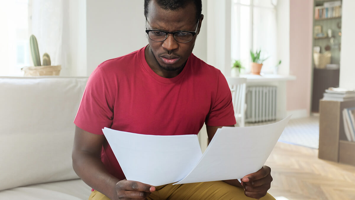 Man comparing Form 944 vs. 941.