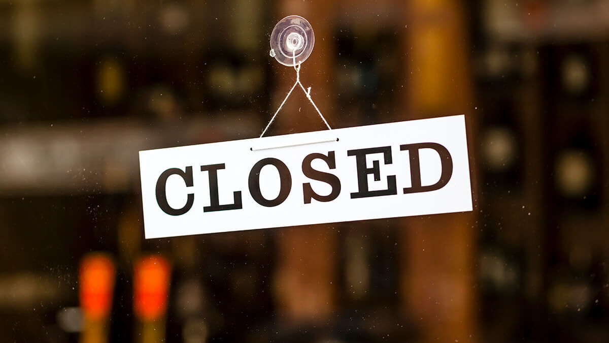 Closed sign on a window front.