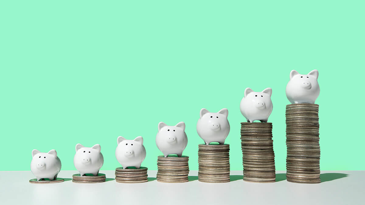 Small piggy banks on rising stacks of coins.
