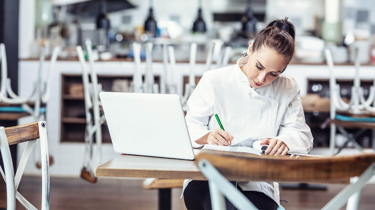 Woman calculating her company's gross income.