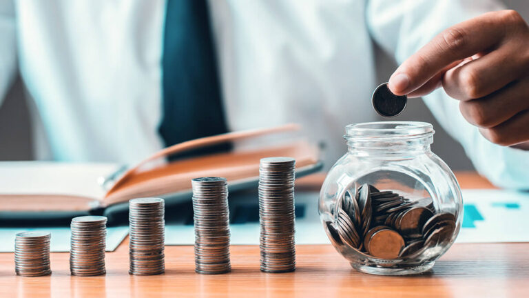 Man with ascending piles of coins dropping them into a glass jar.