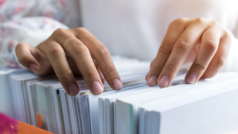 Hands going through files.