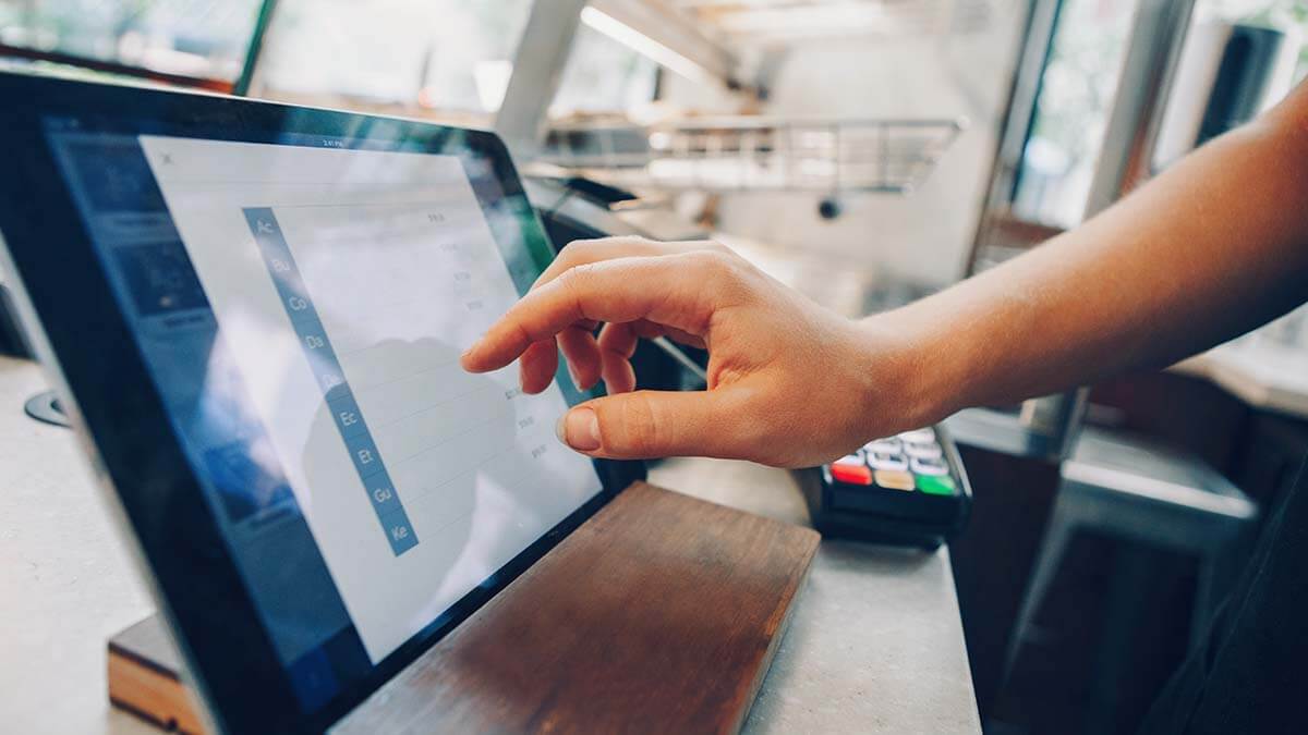 Cashier using a point of sale system.