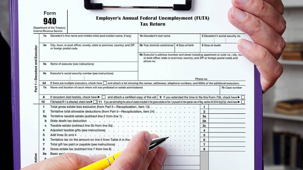 Form 940 on a clipboard.