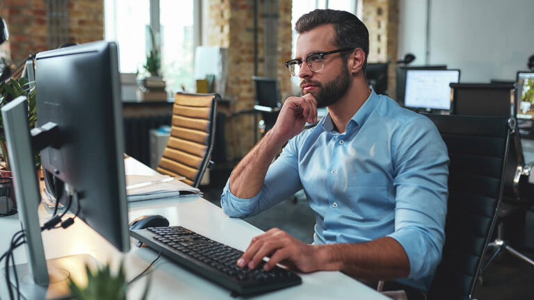 Man in glasses researching how to find net sales.
