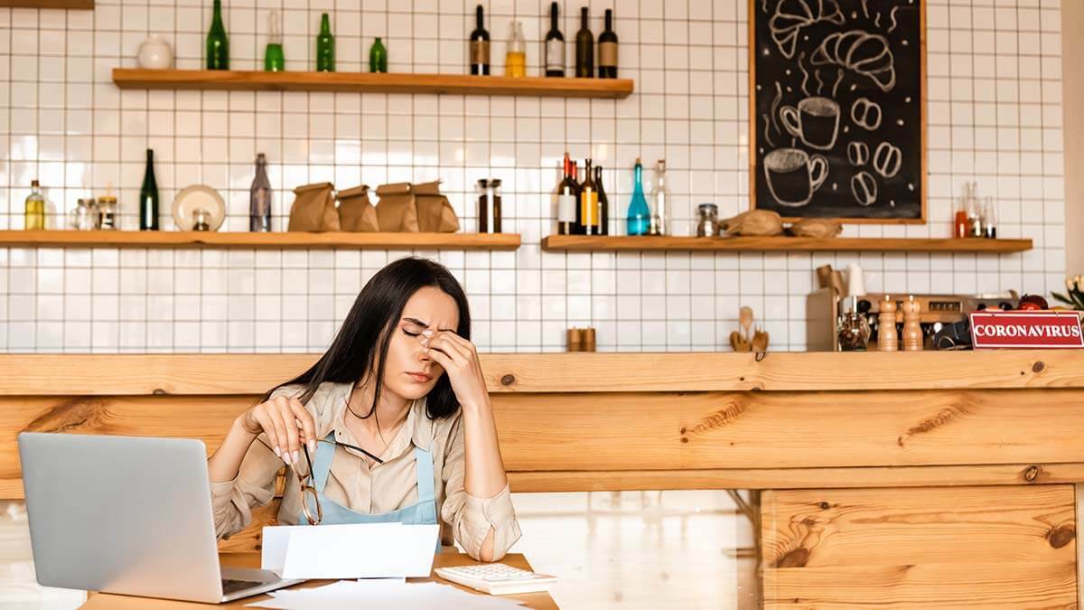 Stressed woman holding the bridge of her nose.