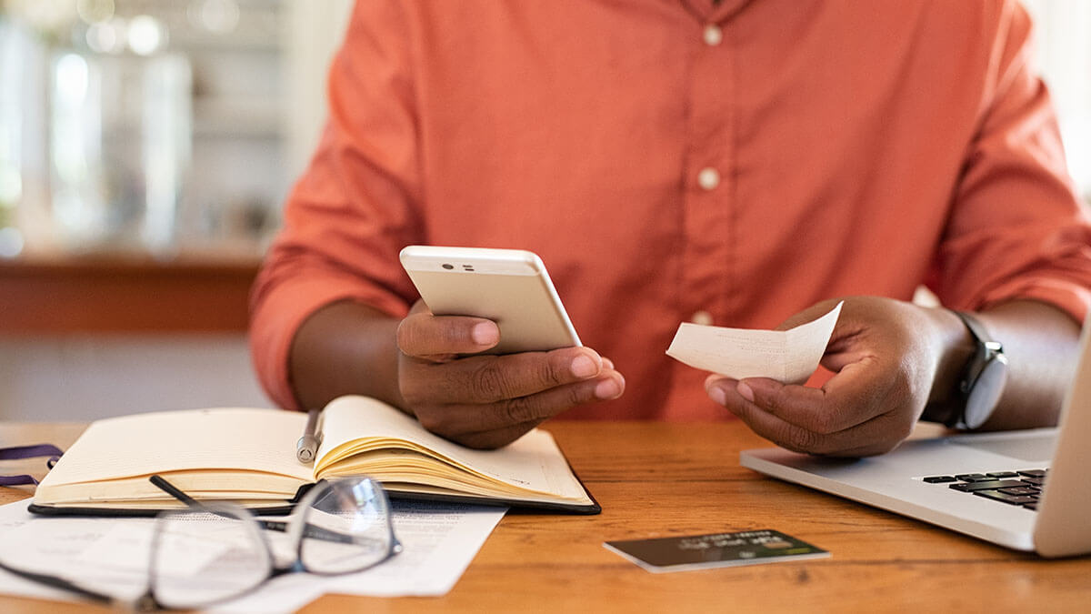 Man trying to organize receipts electronically.