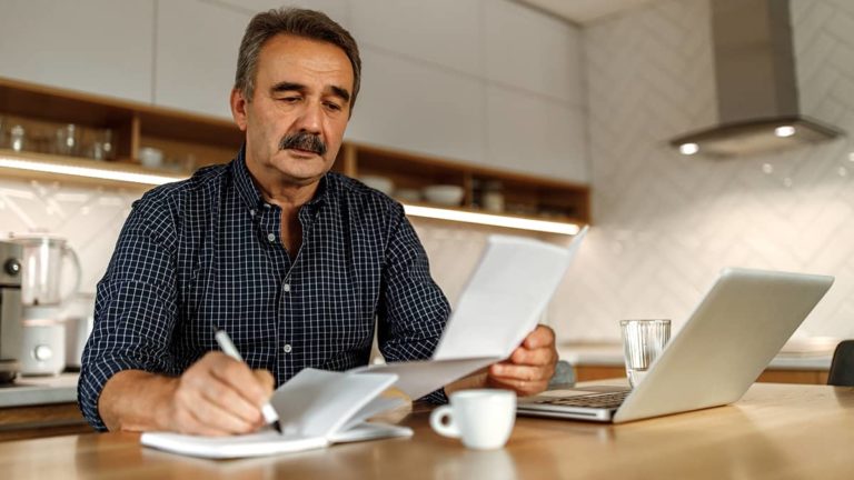 Man writing in a notebook.