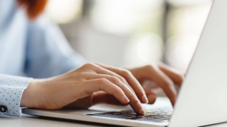 Hands typing on a keyboard.