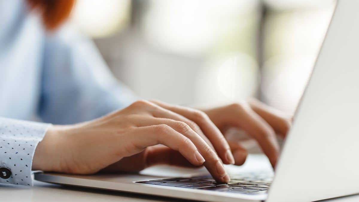 Hands typing on a keyboard.