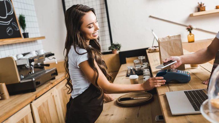 Barista cashing out a customer paying with their phone.
