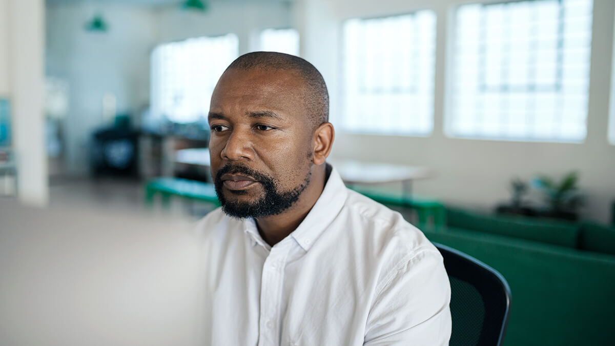 Man looking seriously at a laptop.
