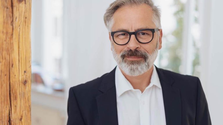 Older man staring at the camera.