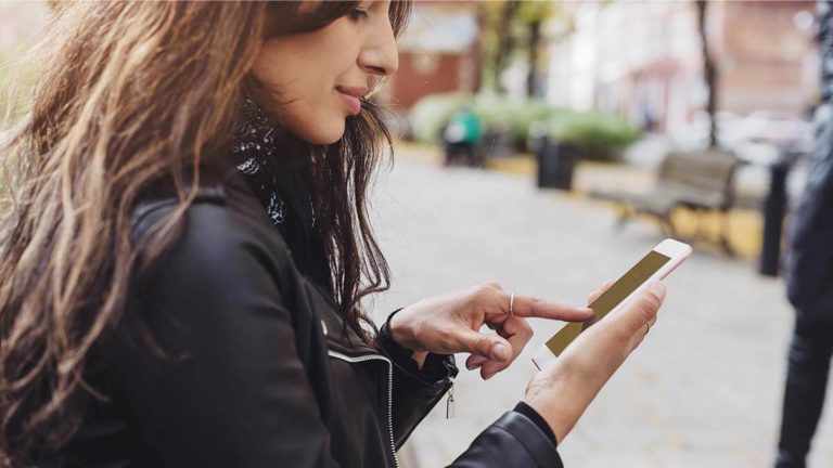 Woman using a cell phone outside.