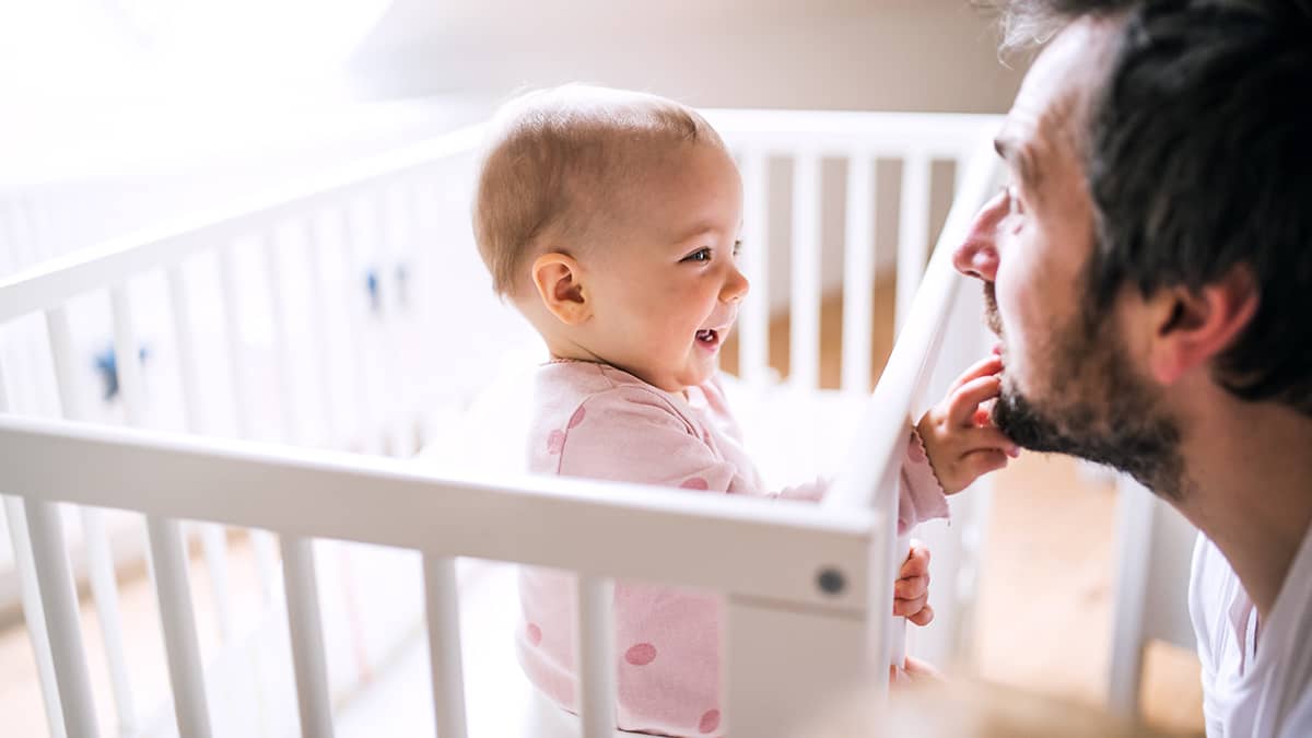 Baby playing with dad's face.