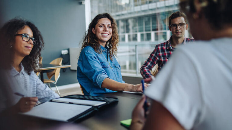 Men and women discussing pay equity laws.