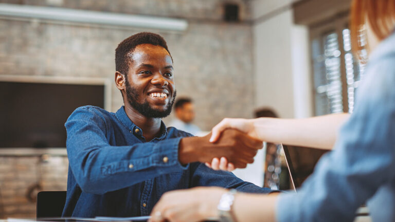 Hiring manager shaking hands with job applicant.