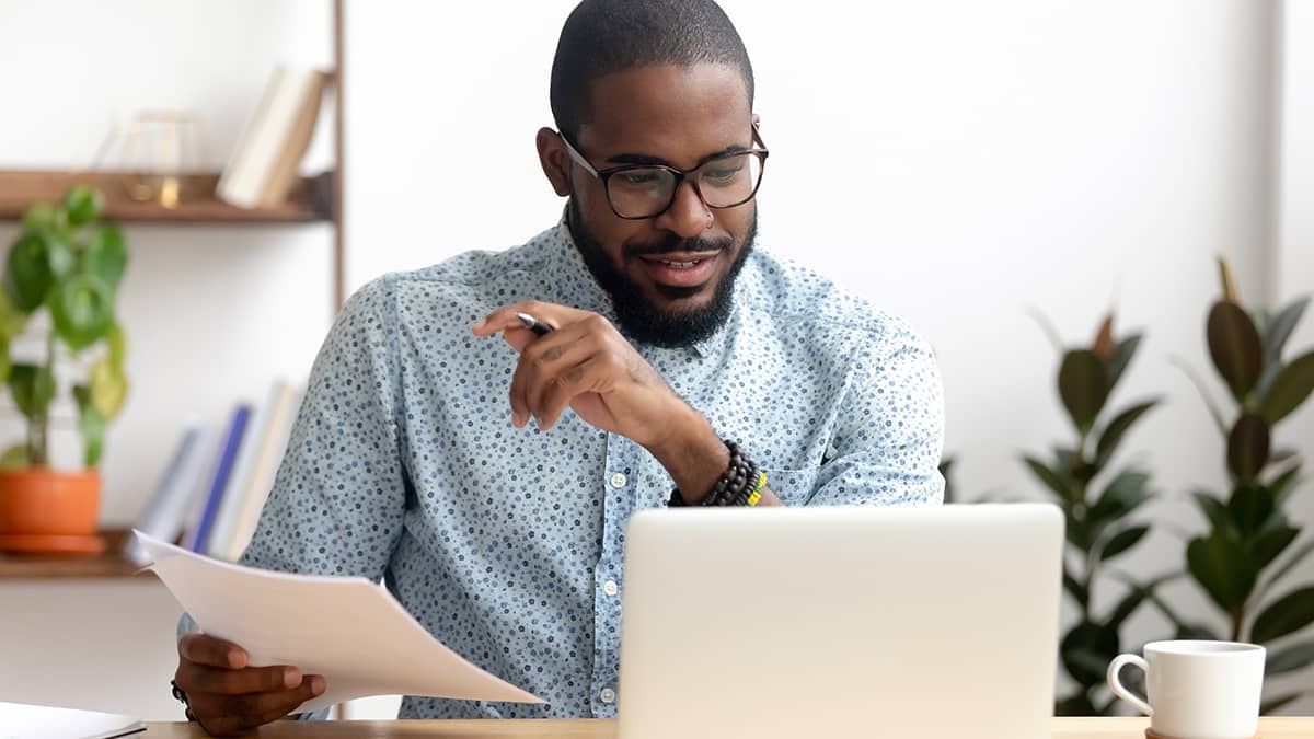 Man posting journal entries to the general ledger online.