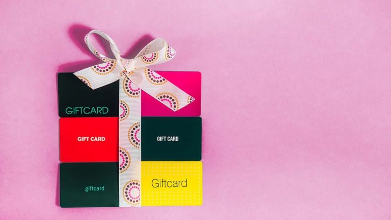 Six gift cards arranged like a package with a bow.