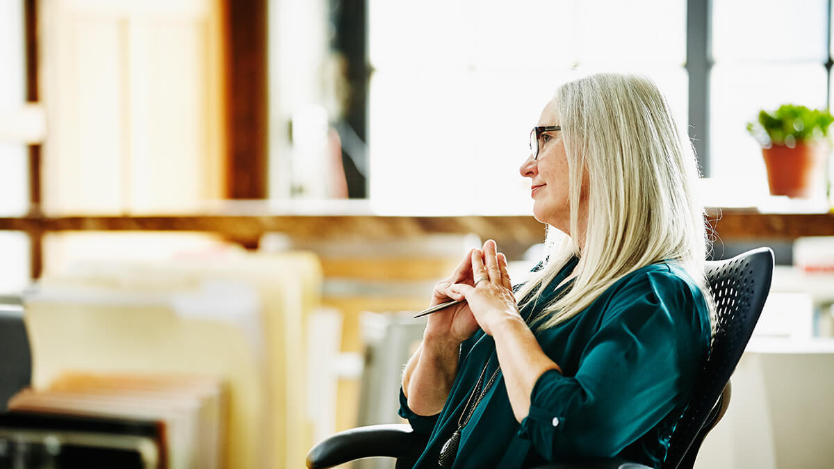 Contemplative woman listening to the pros and cons of direct deposit.