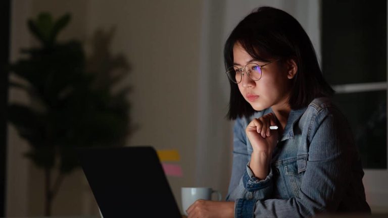 Woman working overtime late at night.