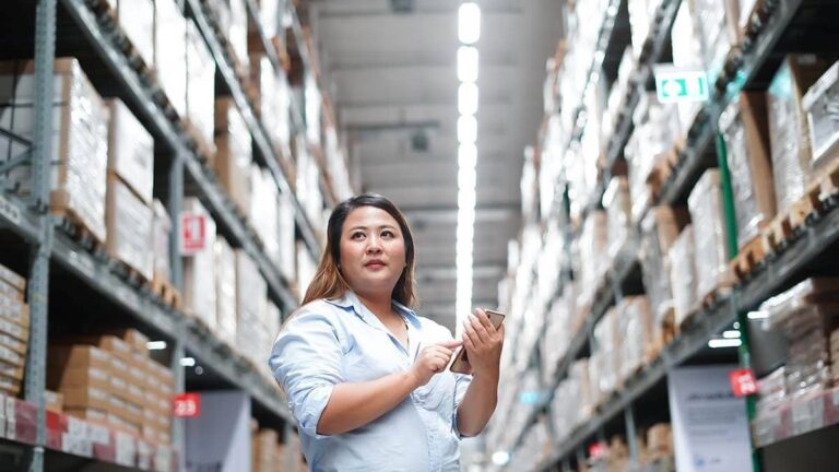 Woman taking inventory in a warehouse.