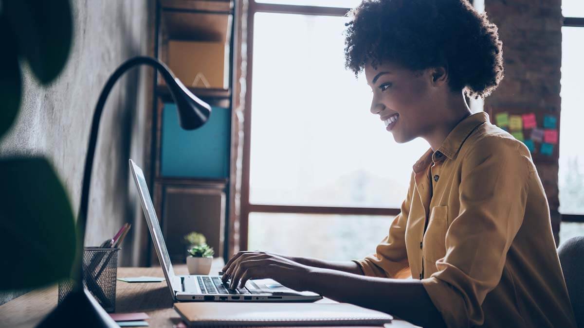 Side profile of a woman on a computer.