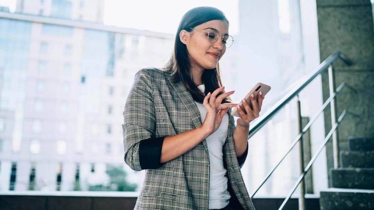 Standing woman using her cell phone.