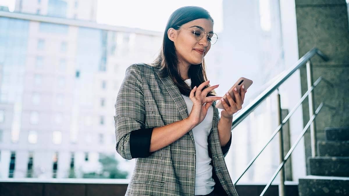 Standing woman using her cell phone.