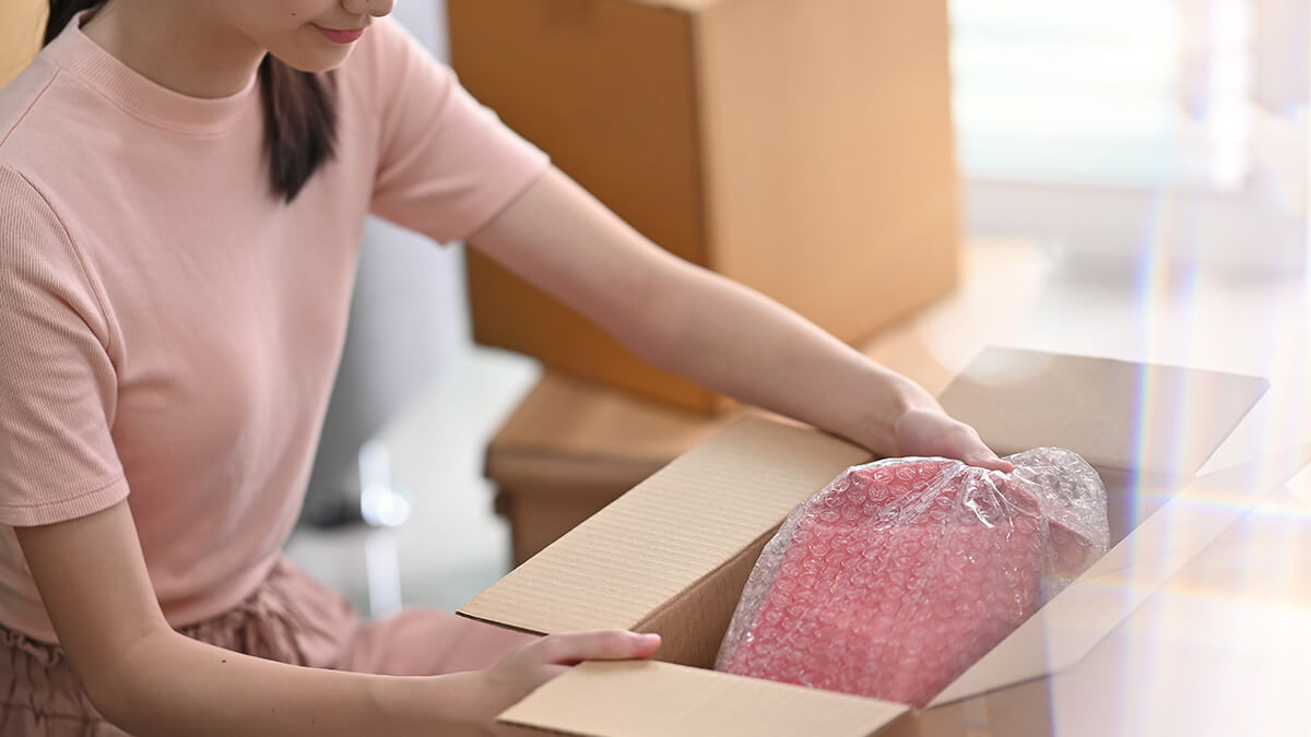 Business owner unboxing a returned garment.
