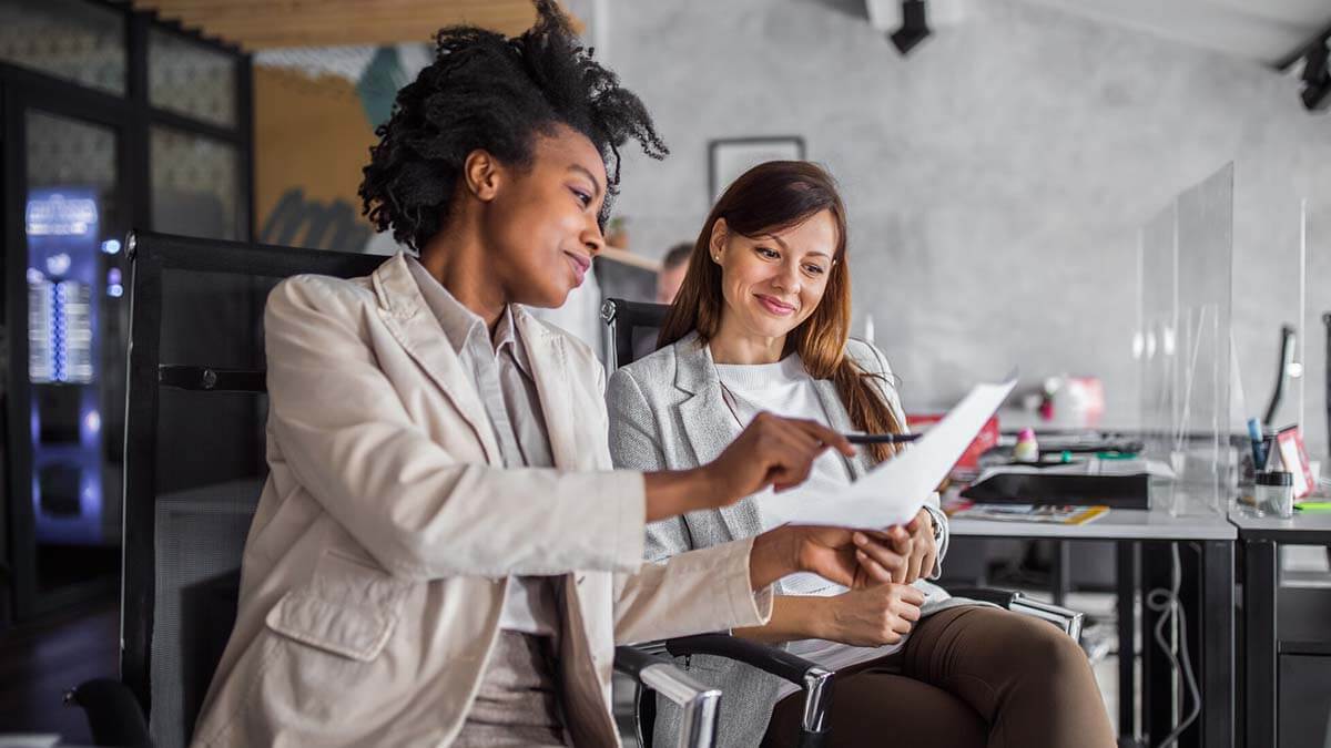 Two co-workers discuss switching payroll companies.