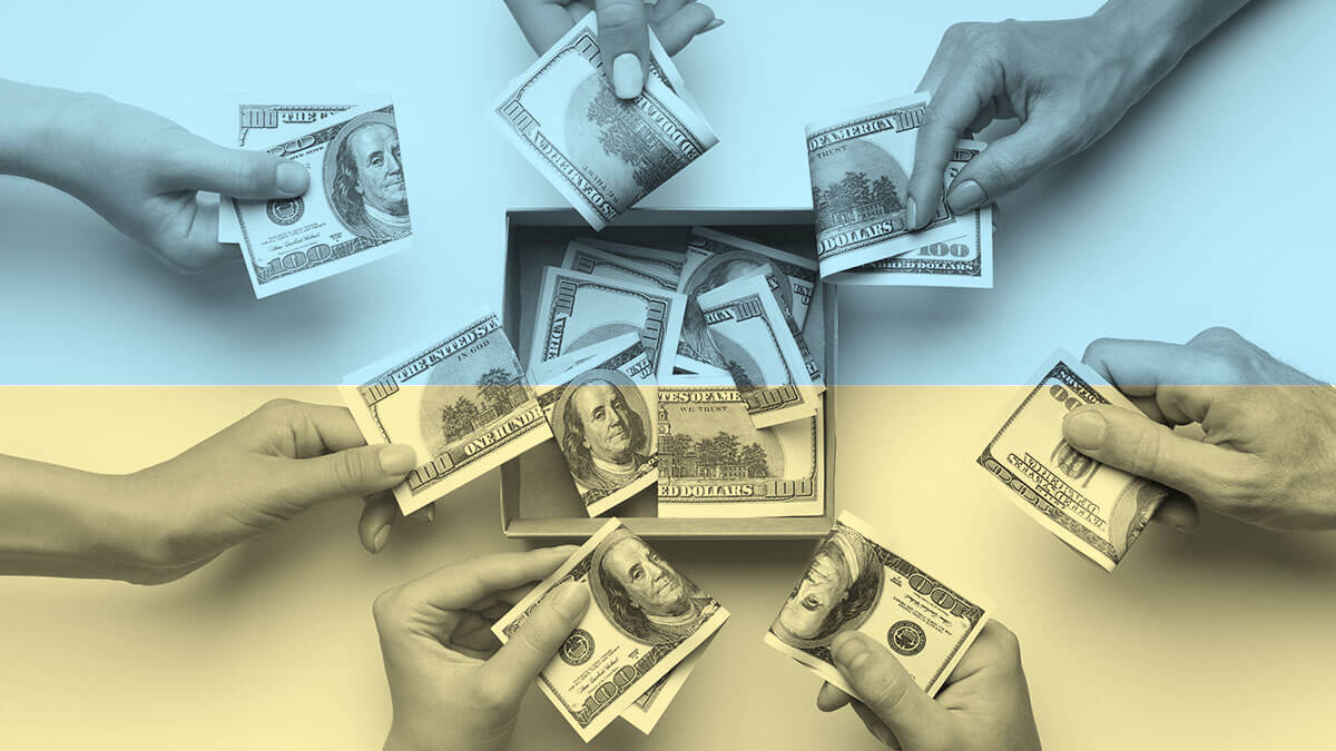 Hands putting $100 bills into a communal box.