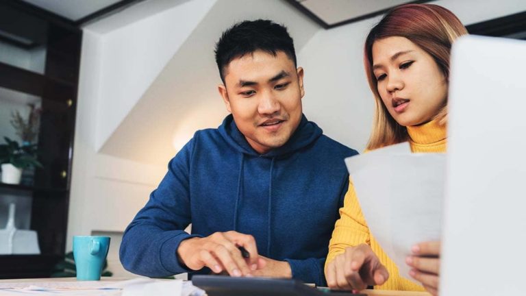 Man and woman working together at a desk.