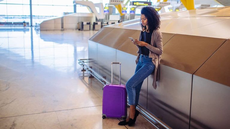 Woman traveling in an airport on vacation.