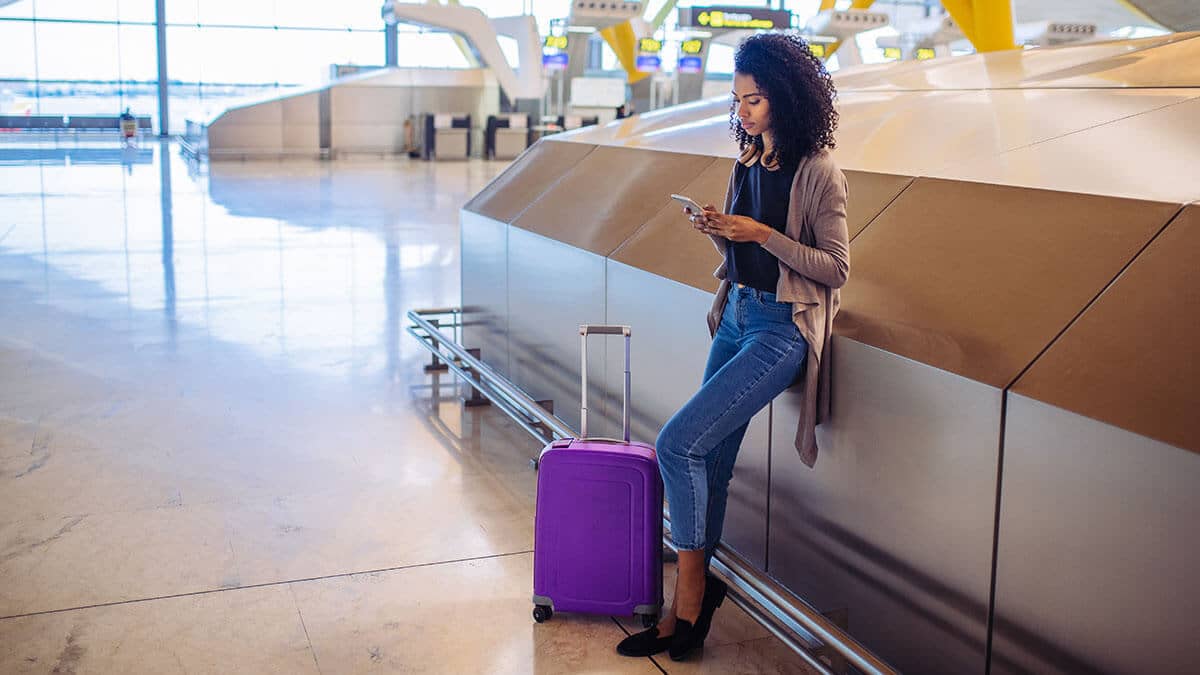 Woman traveling in an airport on vacation.